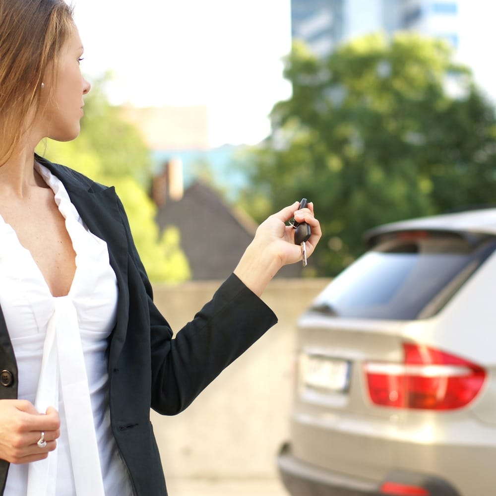 Person uses key fob pointed at car