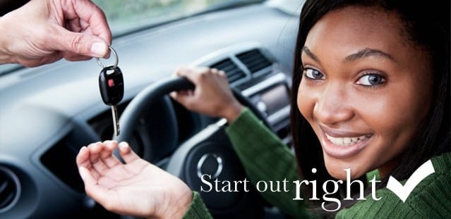 One person the car keys to another person sitting in the driver's seat