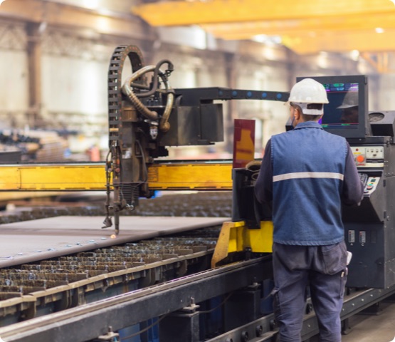 Steel worker on CNC plasma cutter machine